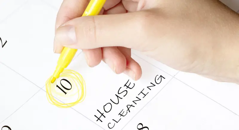 Home cleaning day written on a calendar.